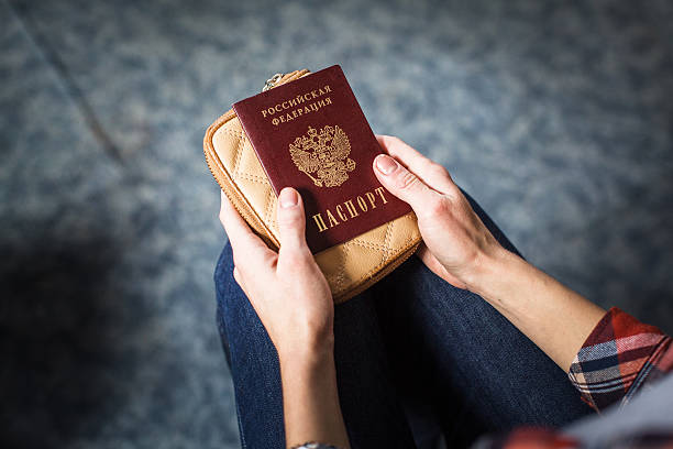 istock girl holding a Russian passport 624695822