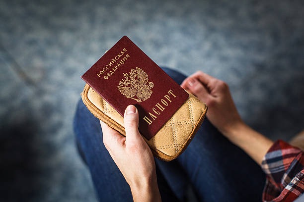 istock girl holding a Russian passport 624695966