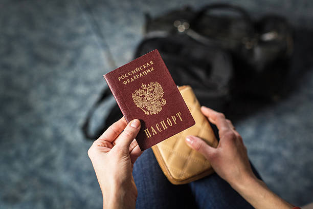istock girl holding a Russian passport 624696326