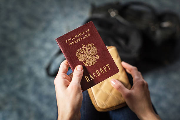 istock girl holding a Russian passport 624696428