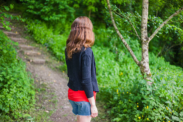 istock Young woman walking in the woods 624696656