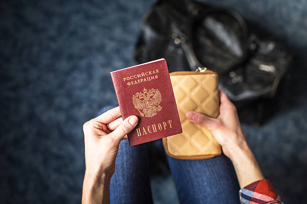 girl holding a Russian passport girl holding Russian passport and purse russian culture stock pictures, royalty-free photos & images