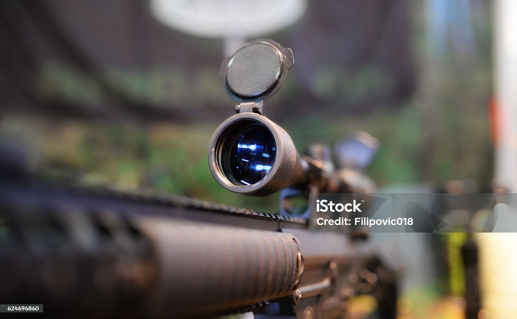 Scoped rifle in army shop Closeup of a rifle scope in army shop Sniper Stock Photo