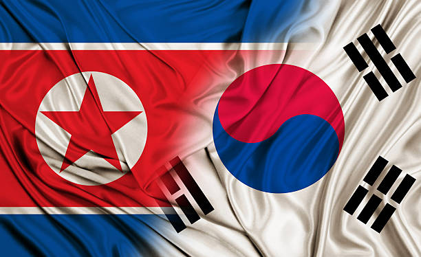 istock North Korea vs South Korea silk flag 624697408