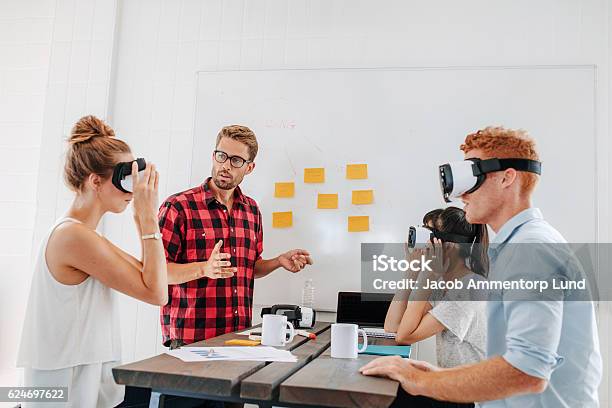 Business Team Testing Virtual Reality Headset In Meeting Stock Photo - Download Image Now