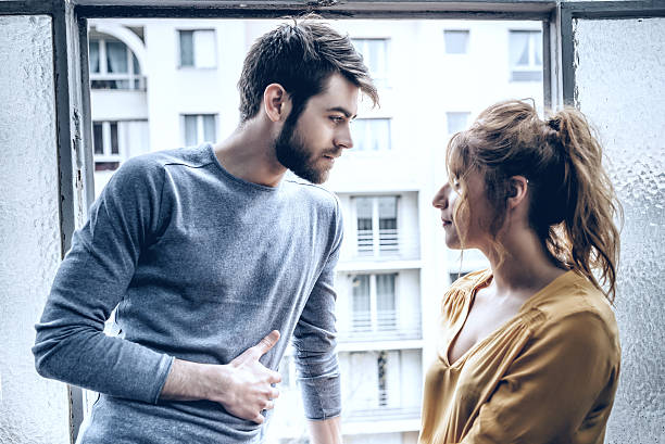 istock young handsome man and beautiful woman looking eachother at window 624698094