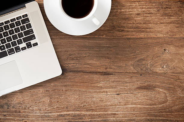 istock Workspace with laptop on distressed wooden desk 624699142