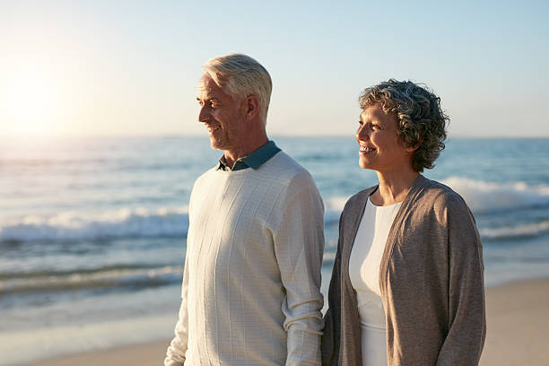 istock Relaxed senior couple walking on the beach 624700222