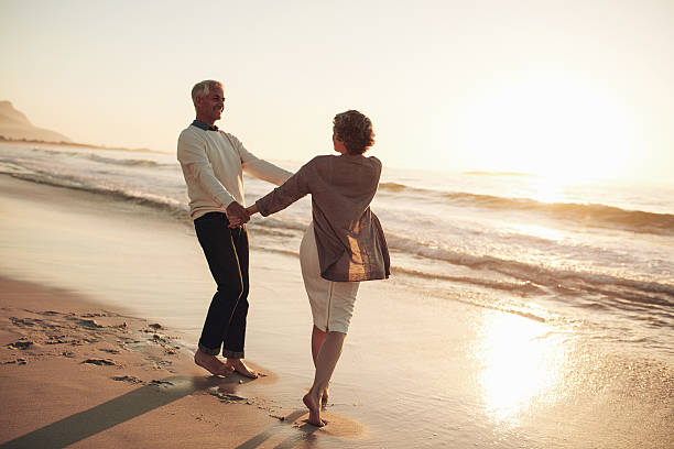 istock Romantic mature couple enjoying a day at the beach 624700360
