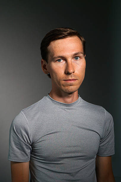 istock Young man in t-shirt on gray background. 624700526