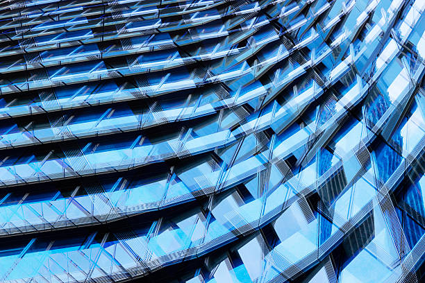 istock Multiple exposure photo of multistory building fragment reflecting blue sky 624700956
