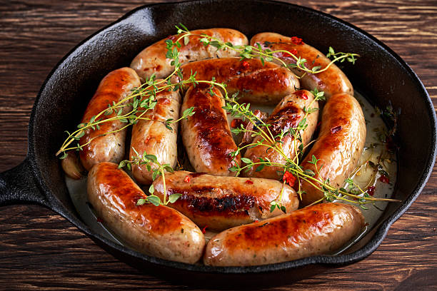 Home-made Pork Sausages in rustic pan with thyme