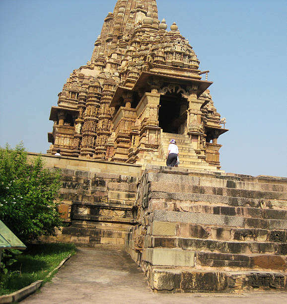 Khajuraho, India - October 10, 2011: Tourists at Kandariya Mahadeva Temple at Khajuraho Group of Monuments in India.