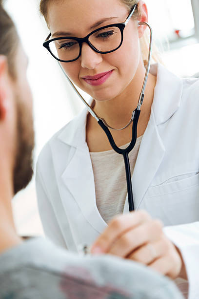 istock Female doctor checking patient heartbeat using stethoscope. 624703740