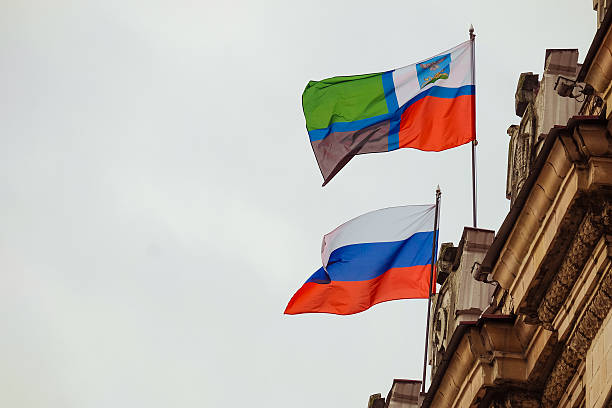 Russian flags Flags of the Russian Federation and the Belgorod region waving on the parapet of the administrative building of the Soviet Stalinist architecture belgorod photos stock pictures, royalty-free photos & images