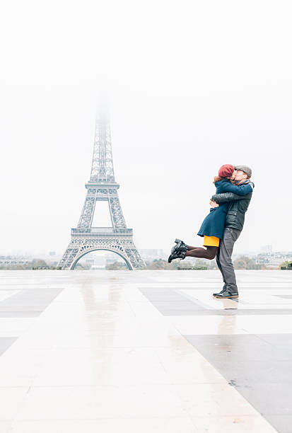 Kiss in Paris Couple hugs and kisses by Eiffel Tower paris france eiffel tower love kissing stock pictures, royalty-free photos & images