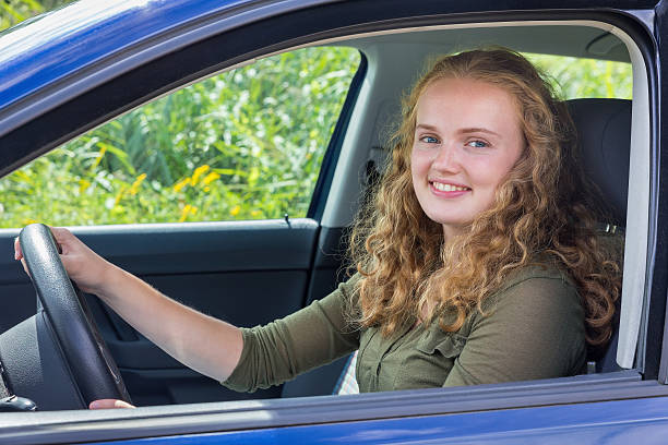 Young caucasian woman driving car stock photo