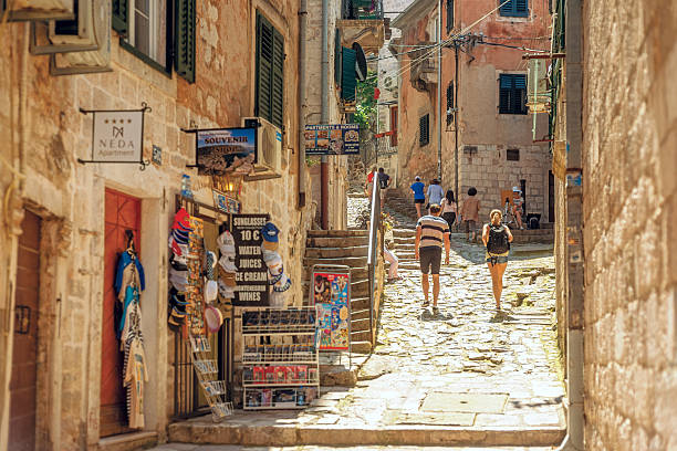 Kotor, Montenegro - June 8, 2016: Street to Saint Giovanni Castle in Kotor, Motenegro. Tourist attraction that bring numerous people. Faces, brands, names and logos visible and recognisable
