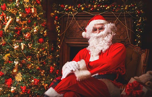 istock Santa Claus with gifts around Christmas tree 624712632