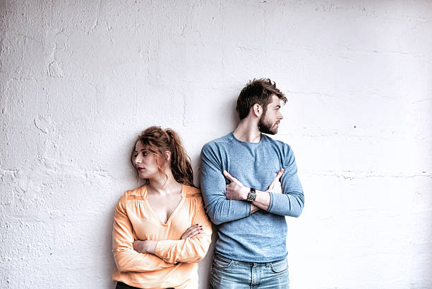 serious young french couple looking in opposite directions - common serious couple men imagens e fotografias de stock