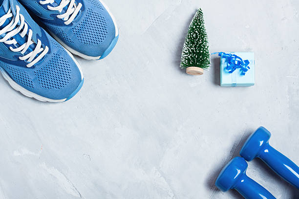 istock Christmas sport composition with shoes, dumbbells and blue gift box 624719058