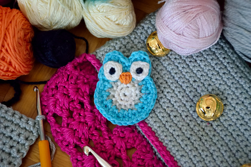 Crochet small blue owl on colorful background