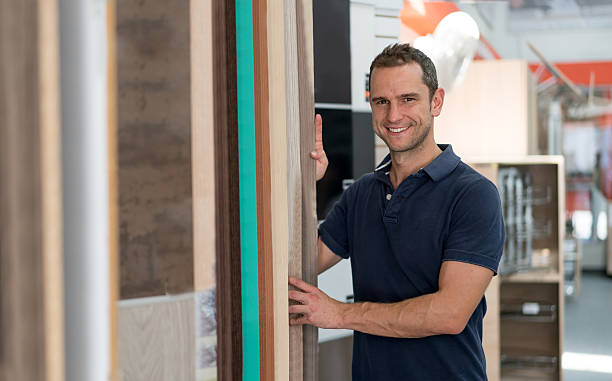 istock Man at a flooring store looking for wood samples 624721000
