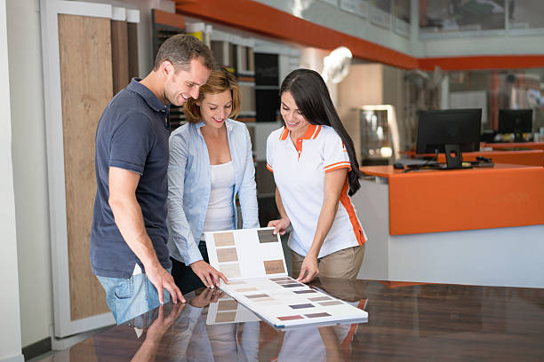 istock Couple at a floor store looking at wood samples 624721068