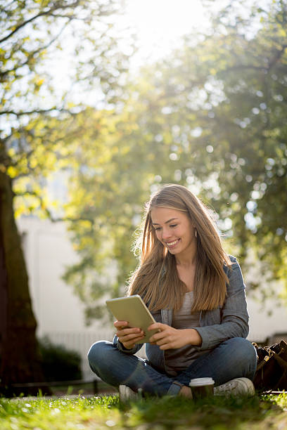 istock Woman working on a tablet computer at the park 624721348