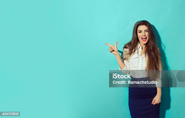 Woman Let Eyelet And Pointing With Finger To The Left Stock Photo - Download Image Now