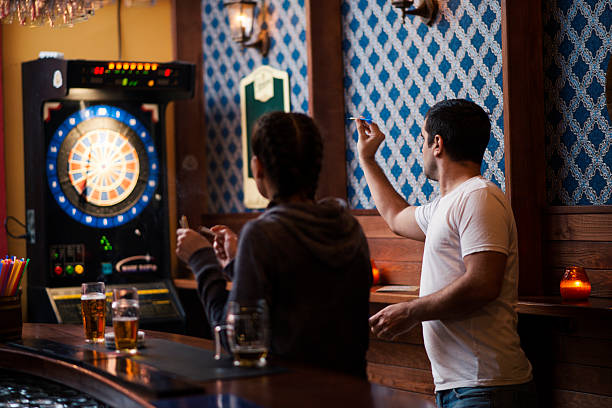 istock Friends playing darts in a club 624723008