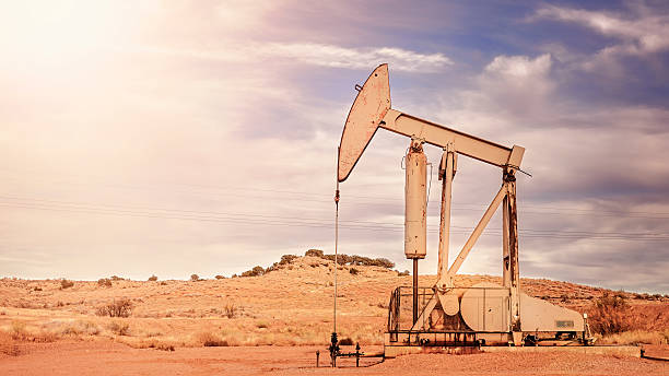 istock Retro toned panoramic picture of old oil pump. 624723314