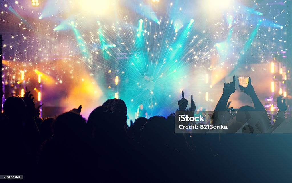 Cheering crowd and fireworks - New Year concept New Year concept - cheering crowd and fireworks in the background Crowd of People Stock Photo