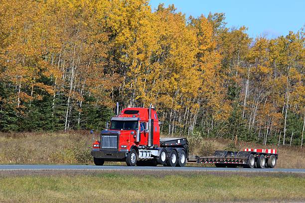 istock Semi truck trailer on an interstate highway, trees in background. 624723496