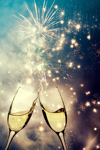 Glasses with champagne against fireworks - NEw Year's concept