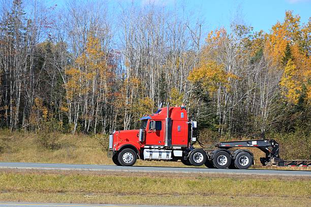 istock Semi truck trailer on an interstate highway, trees in background. 624723702