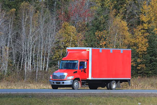 istock Truck on an interstate highway, trees in background. 624723898