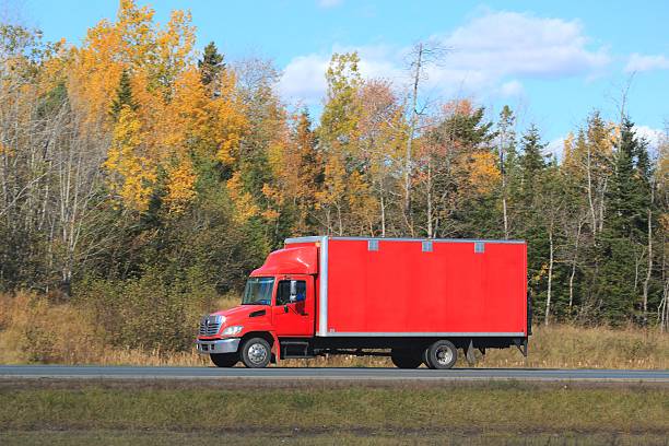 istock Truck on an interstate highway, trees in background. 624723974