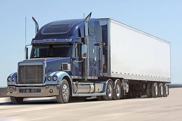 istock Semi Tractor Trailer Truck, Front Quarter View, Panned Shot 624724726