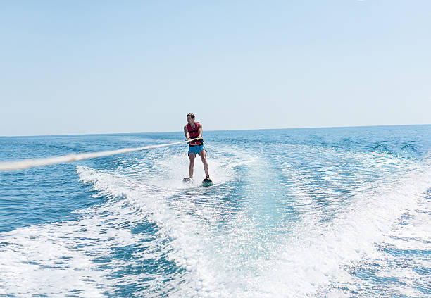istock Young man glides on water skiing on the waves 624739492