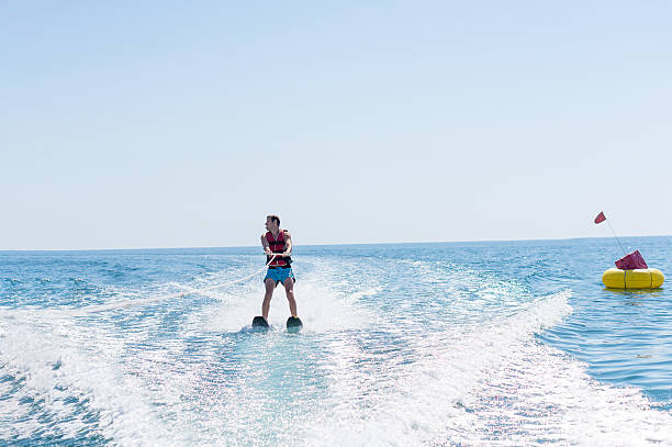 istock Young man glides on water skiing on the waves 624739524