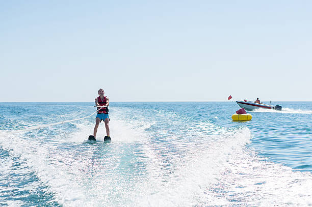 istock Young man glides on water skiing on the waves 624739534