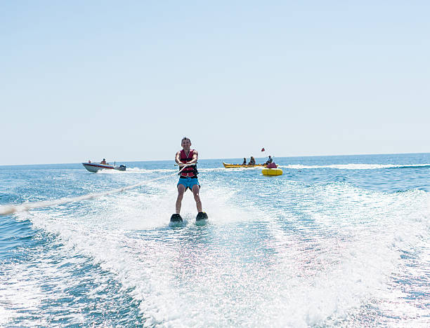 istock man glides on water skiing on the waves on the sea 624739544