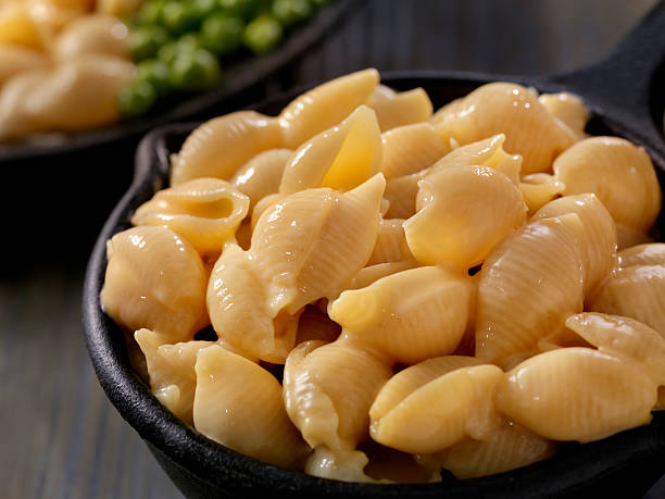 Creamy Shells and Cheese Sauce Creamy Shells and Cheese Carbonara with Peas -Photographed on Hasselblad H3D2-39mb Camera animal shell stock pictures, royalty-free photos & images