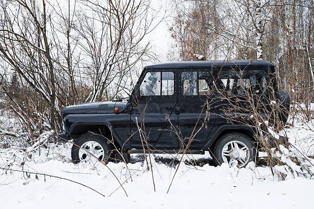 UAZ HUNTER legendary military russian off-road auto. Smolensk, Russia - November 13, 2016: UAZ HUNTER legendary military russian off-road auto parked in the winter forest.. uaz 4x4 land vehicle woods stock pictures, royalty-free photos & images