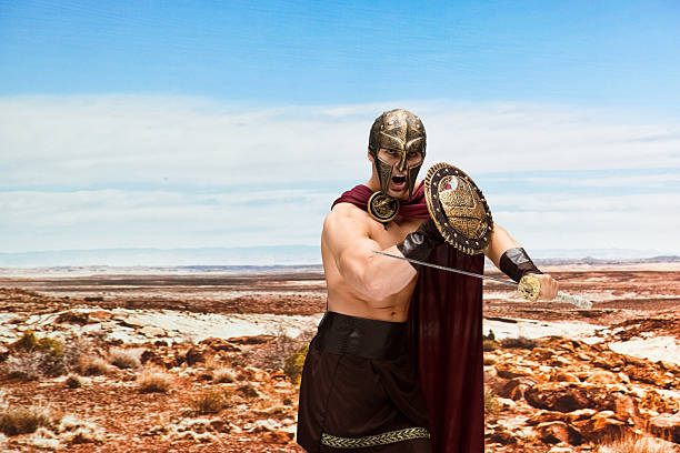 gladiator lucha en el desierto - 20s standing one man only sword fotografías e imágenes de stock