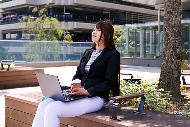 istock Young business woman relaxing on bench 624743470