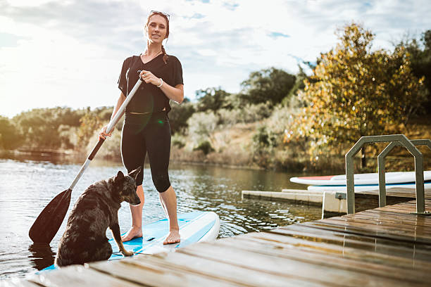 istock Paddleboarding Woman With Dog 624744640