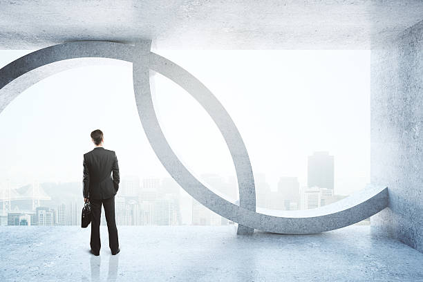 istock Businessman in concrete interior 624744888