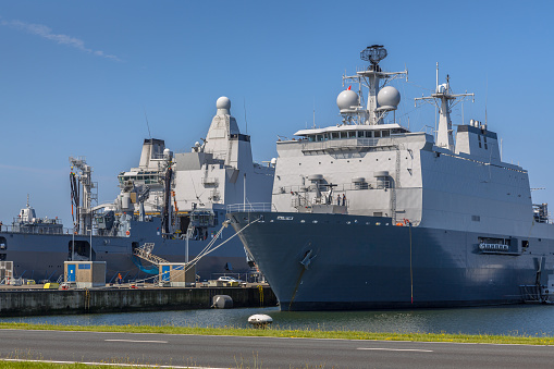 Dutch navy ships in a harbor, loading for their next mission at Den Helder naval base